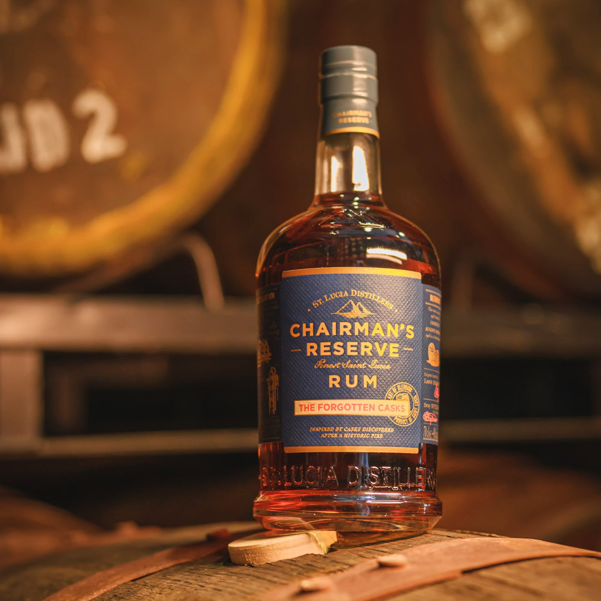 Chairman's Reserve Forgotten Casks Rum bottle with barrels in the background