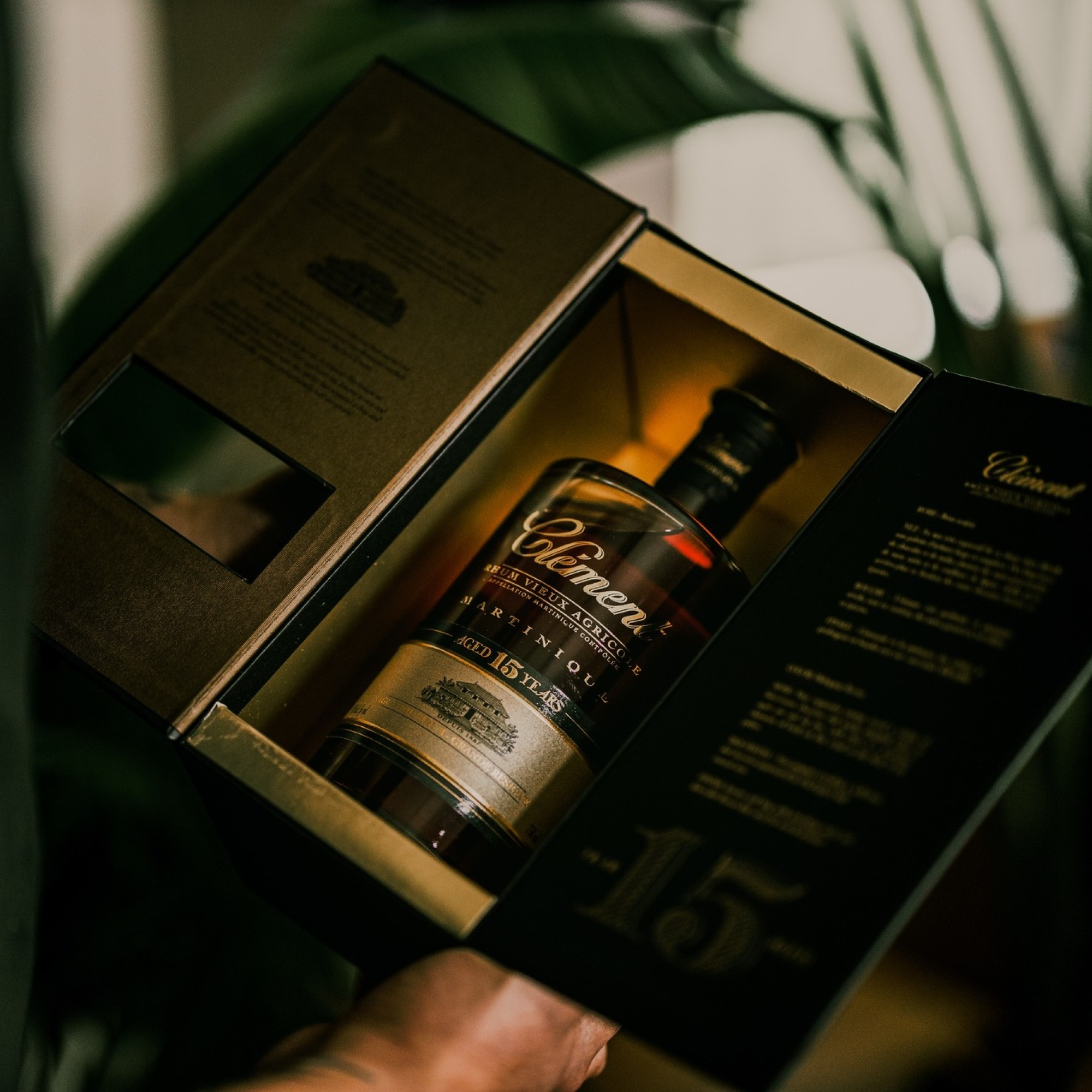 Bottle of Clement rhum in an open box with a blurred background